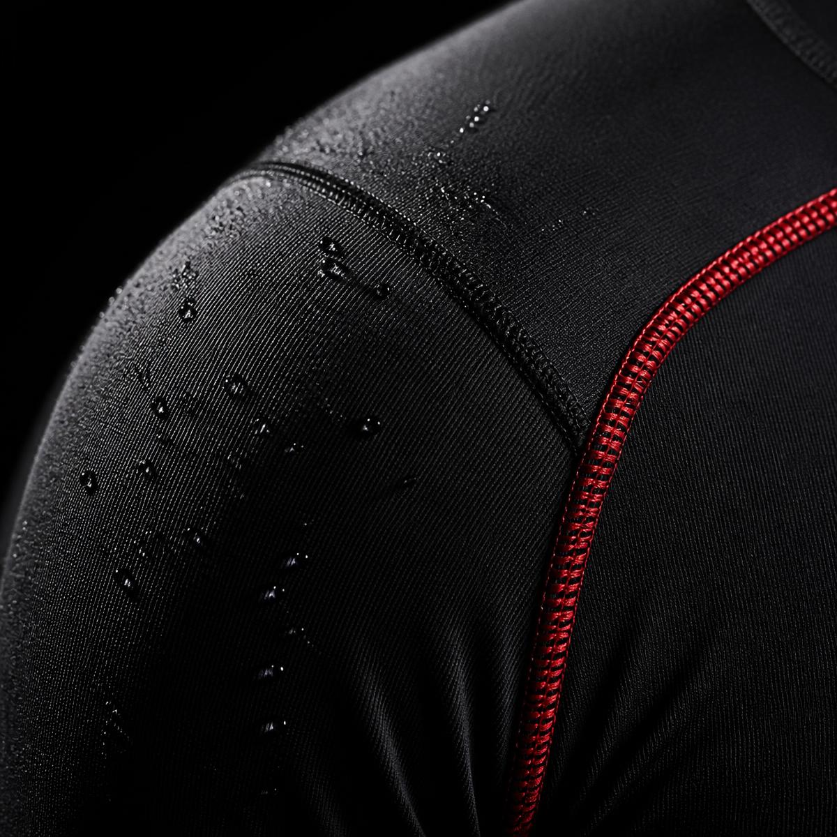 Macro detail of JUNGJU rashguard fabric with red accent seam